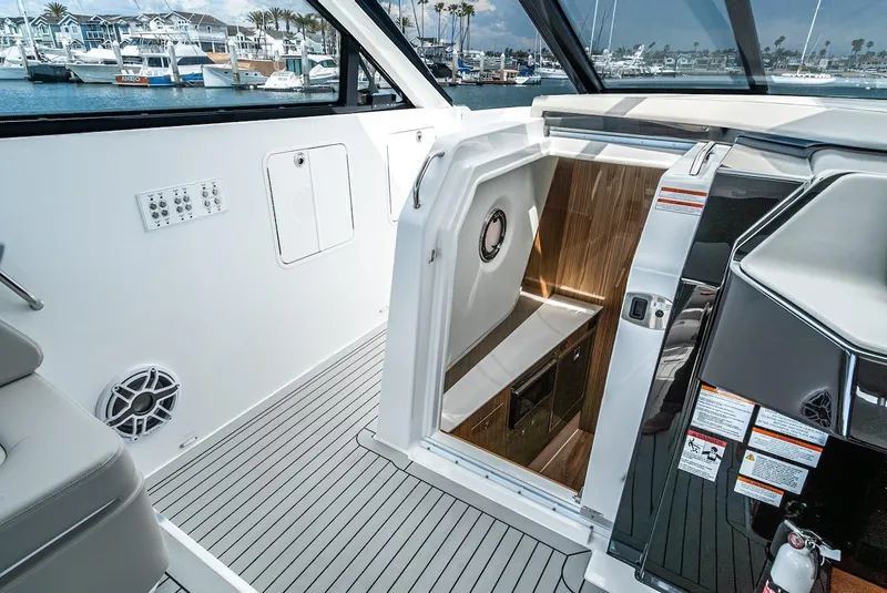 Slide: The Image of 2024 Cruisers Yachts 50 GLS interior cabin entrance with modern design and marina view. - 49