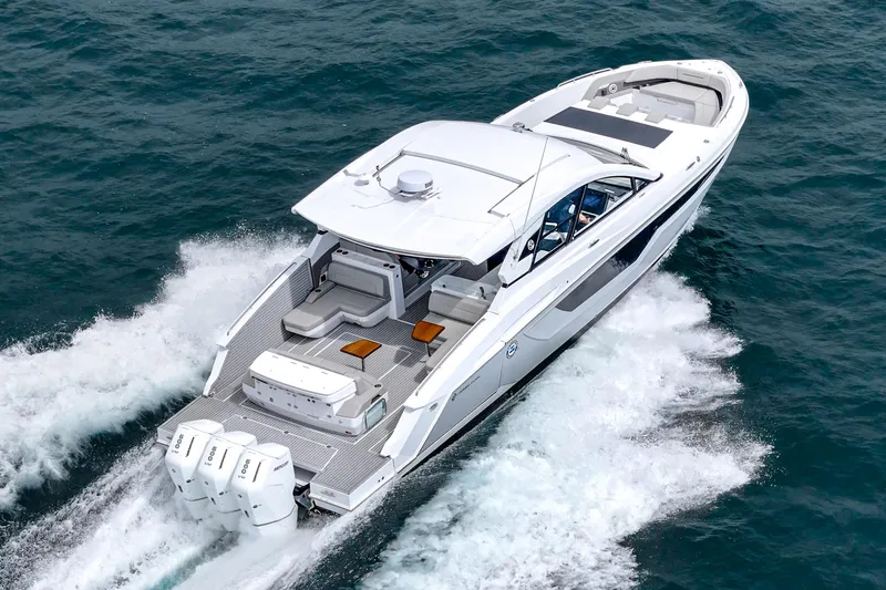 Slide: The Image of 2024 Cruisers Yachts 50 GLS luxury boat cruising on open water. - 5