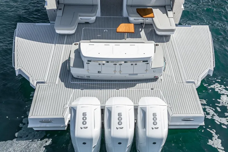 Slide: The Image of 2024 Cruisers Yachts 50 GLS with triple V12 engines on the water. - 12