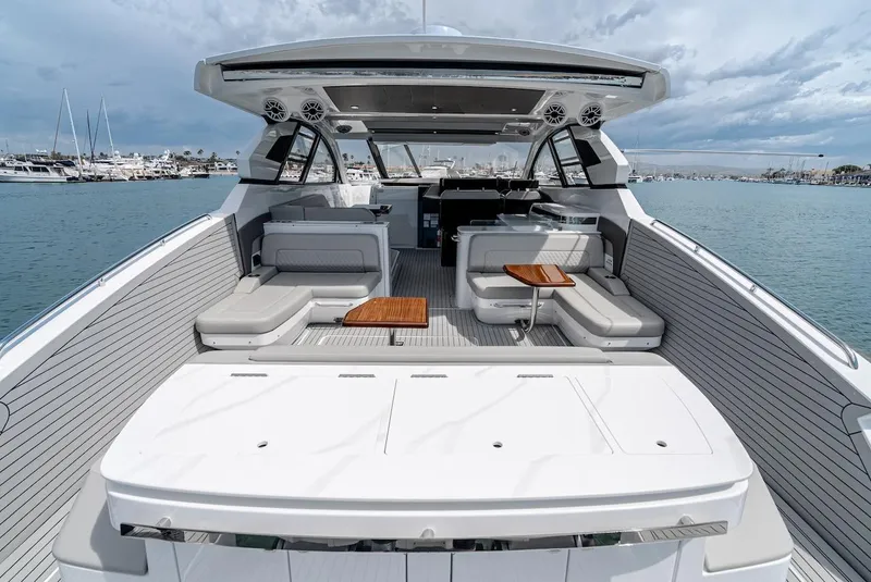 Slide: The Image of 2024 Cruisers Yachts 50 GLS luxury boat interior with seating and tables. - 27