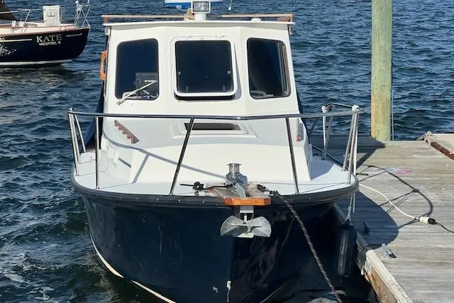 Slide: The Image of 2007 Eastern 27 Islander boat docked on calm water, front view. - 2