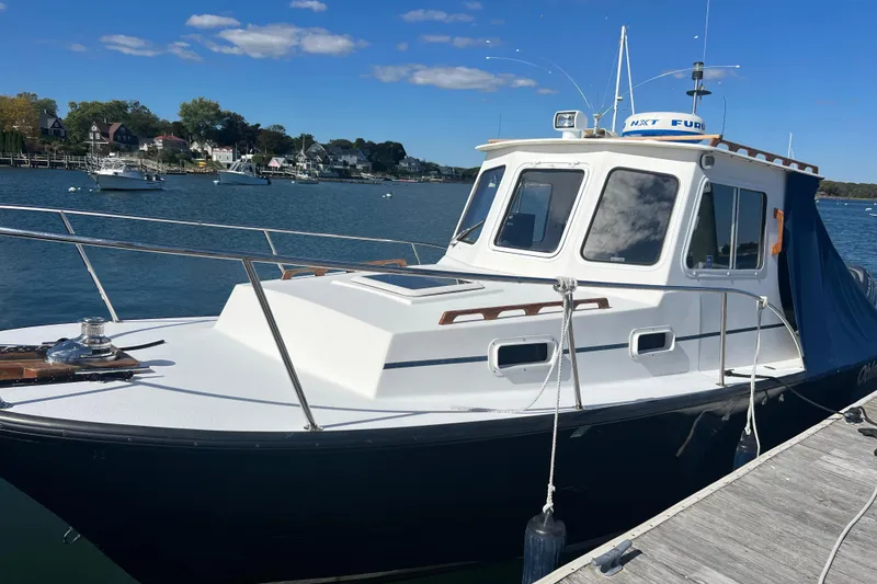 Slide: The Image of 2007 Eastern 27 Islander boat docked on a sunny day with scenic waterfront background. - 3