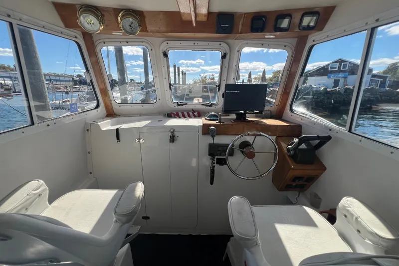 Slide: The Image of Interior of 2007 Eastern 27 Islander boat with steering wheel and navigation equipment. - 5