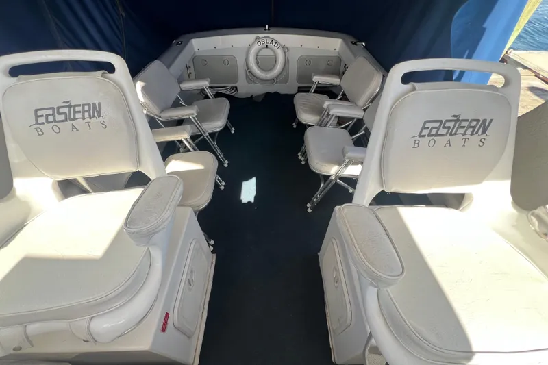 Slide: The Image of Interior of 2007 Eastern 27 Islander boat with white seating and blue canopy. - 9