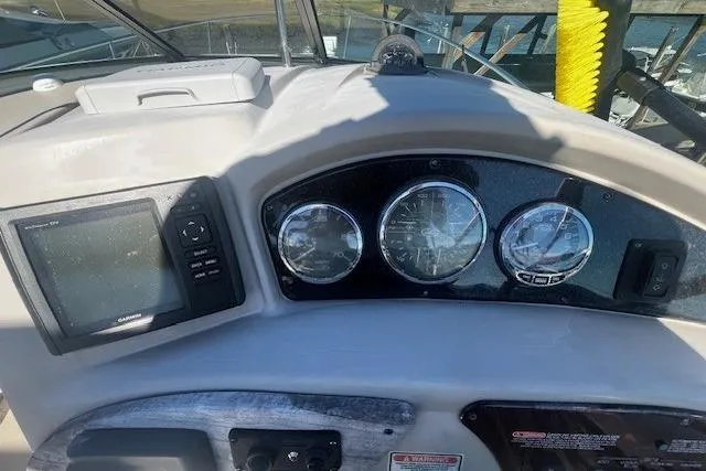 Slide: The Image of 2006 Searay 240 Sundancer dashboard with gauges and Garmin navigation system. - 7