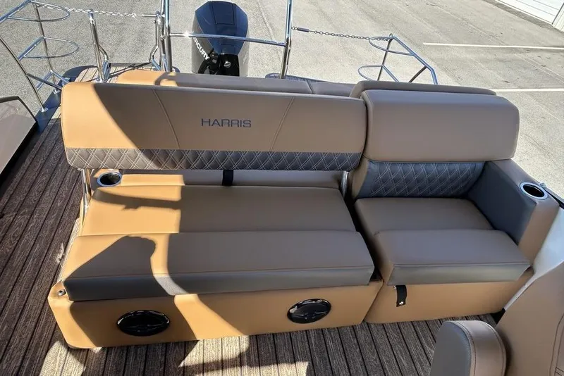 Slide: The Image of 2026 Harris Cruiser 250 LUX boat seating with tan upholstery and cup holders. - 13
