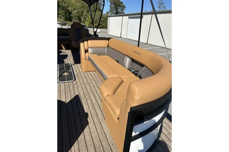 Slide: The Image of Luxurious seating on 2026 Harris Cruiser 250 LUX pontoon boat, featuring tan upholstery. - 3