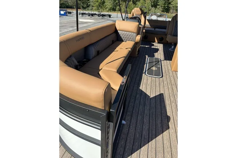 Slide: The Image of 2026 Harris Cruiser 250 LUX pontoon boat with luxurious tan seating and spacious deck. - 4