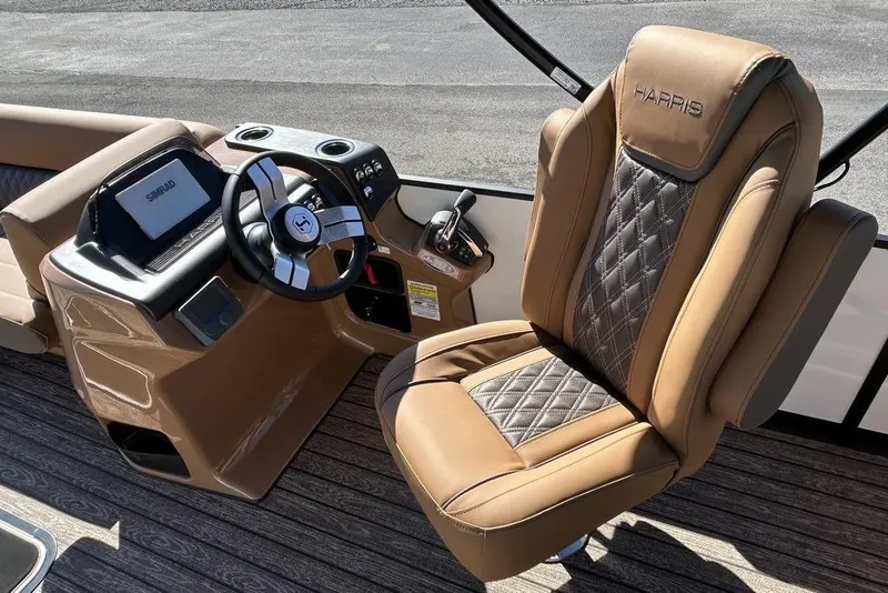 Slide: The Image of 2026 Harris Cruiser 250 LUX boat interior with luxurious captain's chair and modern dashboard. - 6