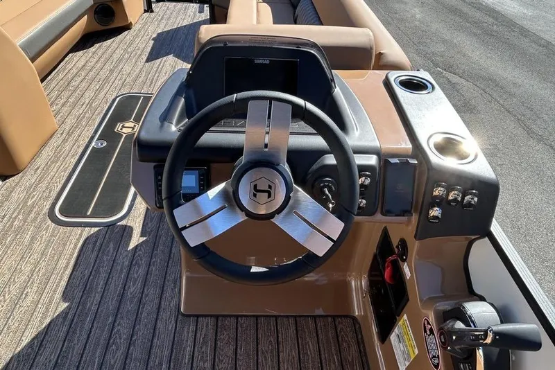 Slide: The Image of 2026 Harris Cruiser 250 LUX boat dashboard with steering wheel and controls. - 9