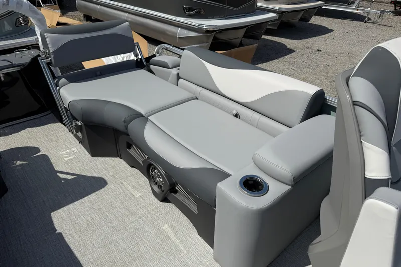 Slide: The Image of 2026 Avalon LSZ Quad Lounger Shift boat interior with gray seating and cup holder. - 10