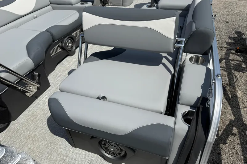 Slide: The Image of 2026 Avalon LSZ Quad Lounger Shift boat interior with gray seating and cup holders. - 11