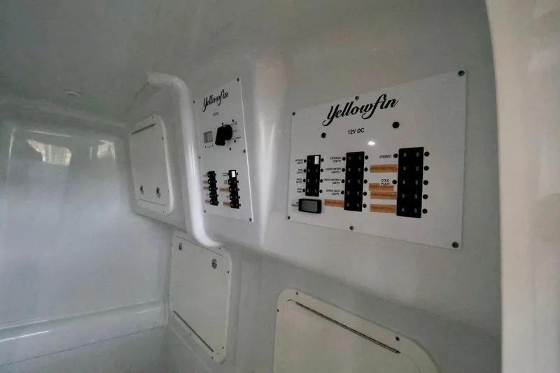 Slide: The Image of 2023 Yellowfin 42 Offshore boat interior with control panels and storage compartments. - 14
