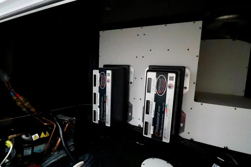 Slide: The Image of Electrical components inside a 2023 Yellowfin 42 Offshore boat, featuring ProVolt systems. - 16