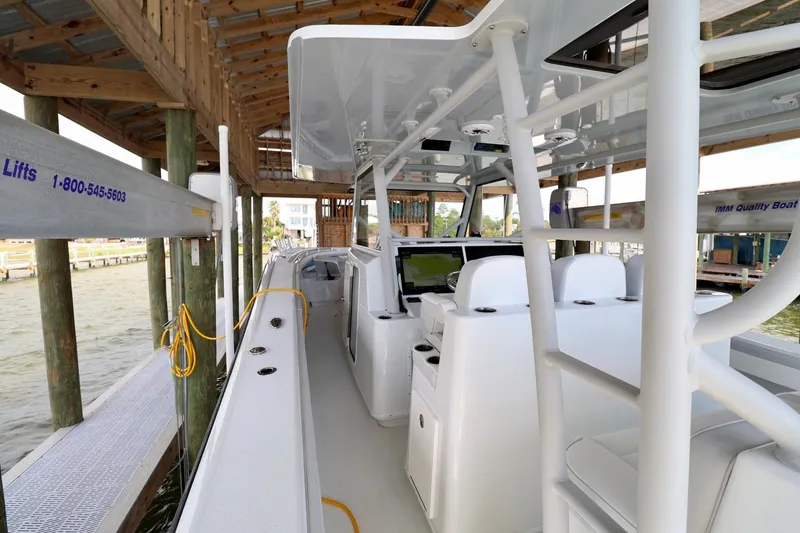 Slide: The Image of 2023 Yellowfin 42 Offshore boat docked, showcasing sleek interior and advanced navigation systems. - 18