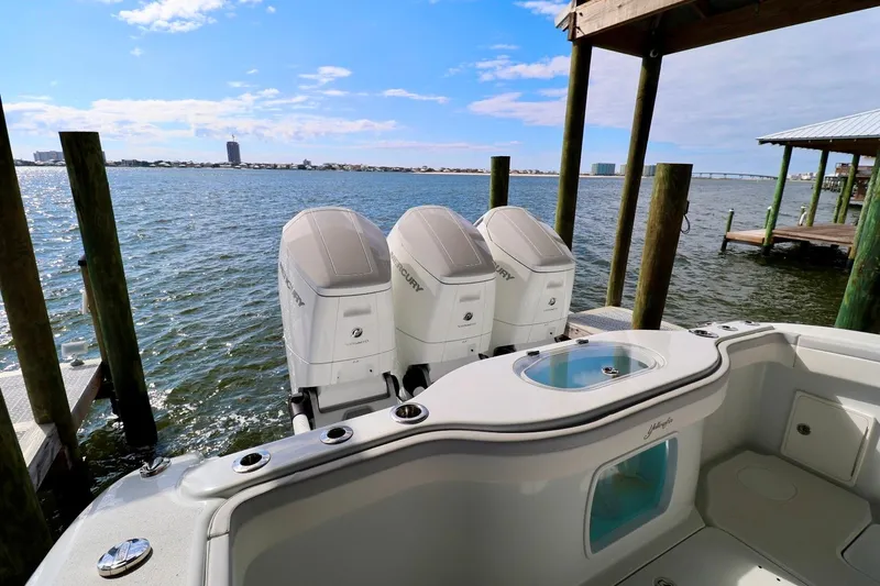 Slide: The Image of 2023 Yellowfin 42 Offshore boat with triple Mercury engines docked by the water. - 21