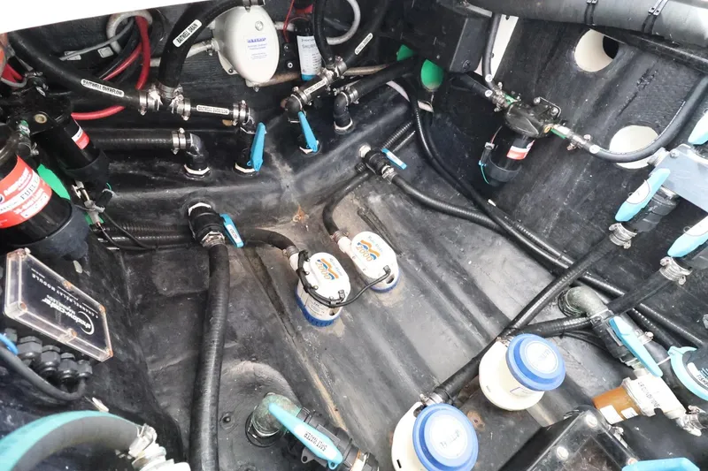 Slide: The Image of Engine compartment of a 2023 Yellowfin 42 Offshore boat, showcasing complex wiring and components. - 22
