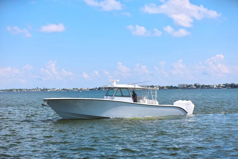 Slide: The Image of 2023 Yellowfin 42 Offshore boat cruising on a sunny day with blue skies. - 24