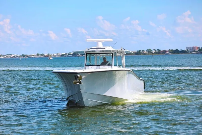 Slide: The Image of 2023 Yellowfin 42 Offshore boat cruising on open water under a clear blue sky. - 27