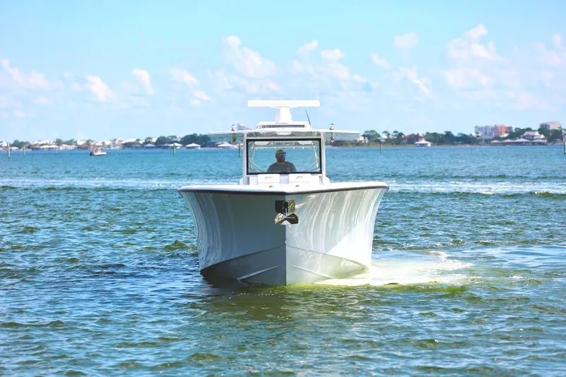 Slide: The Image of 2023 Yellowfin 42 Offshore boat cruising on open water under a clear blue sky. - 28