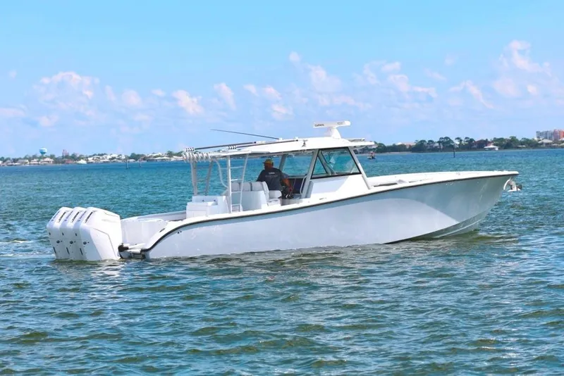 Slide: The Image of 2023 Yellowfin 42 Offshore boat cruising on calm waters under a clear blue sky. - 29