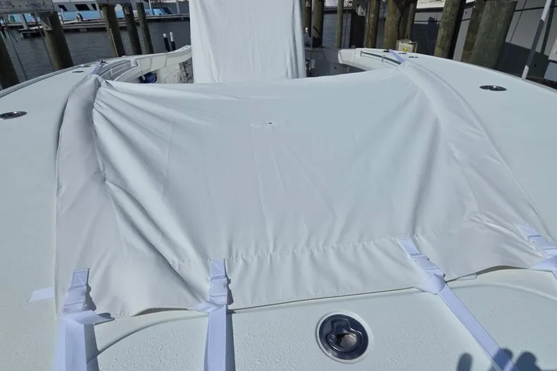 Slide: The Image of 2023 Yellowfin 42 Offshore boat with white cover at dock. - 3