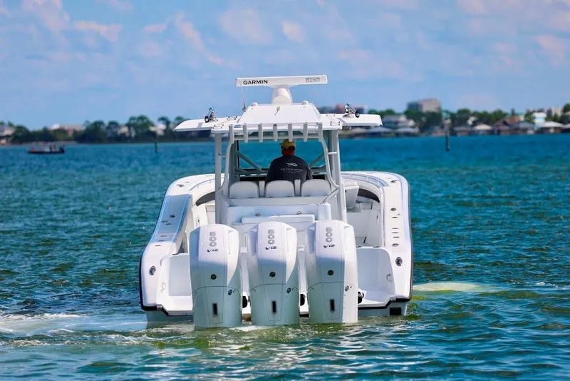 Slide: The Image of 2023 Yellowfin 42 Offshore boat cruising on open water with triple engines. - 32