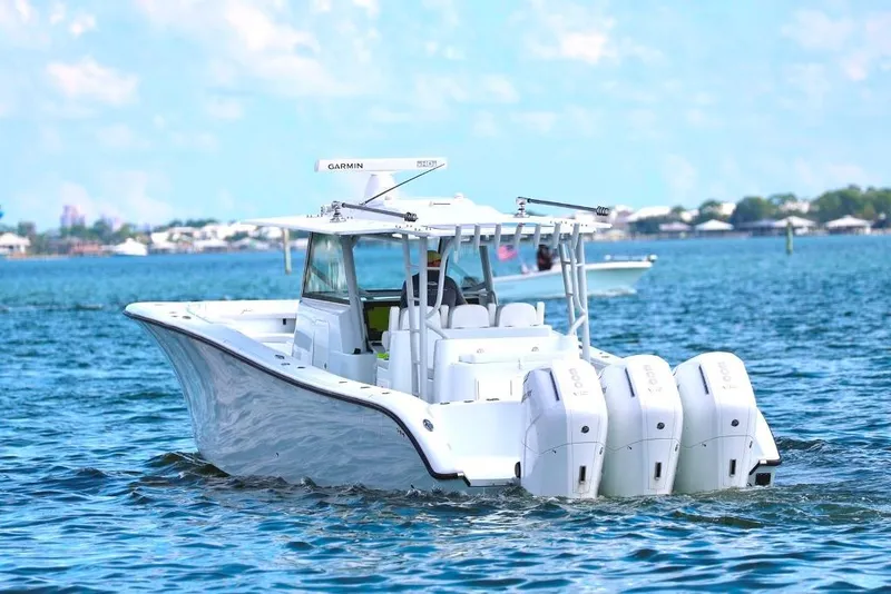 Slide: The Image of 2023 Yellowfin 42 Offshore boat cruising on blue water with multiple engines. - 34