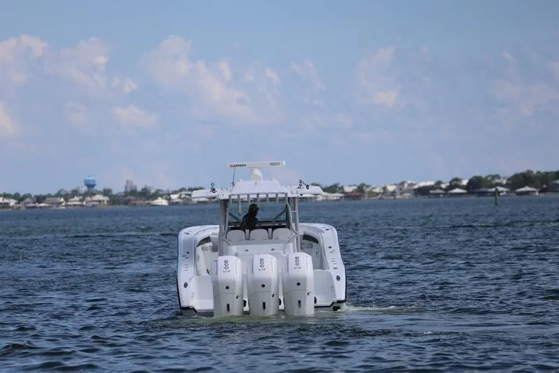 Slide: The Image of 2023 Yellowfin 42 Offshore boat cruising on open water, rear view. - 35