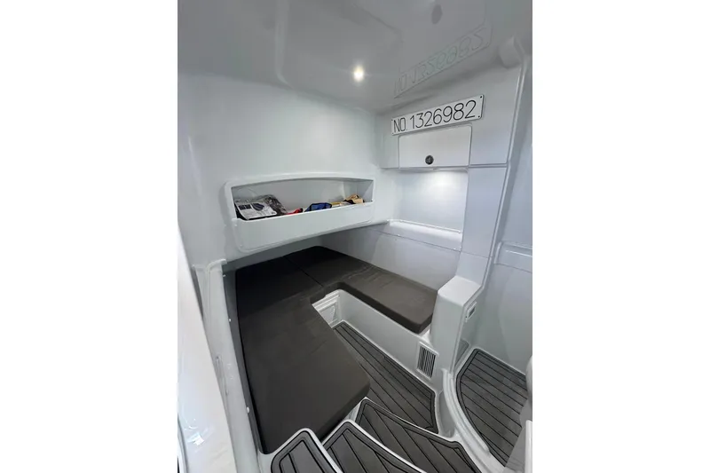 Slide: The Image of 2023 Yellowfin 42 Offshore cabin interior with seating and storage. - 5