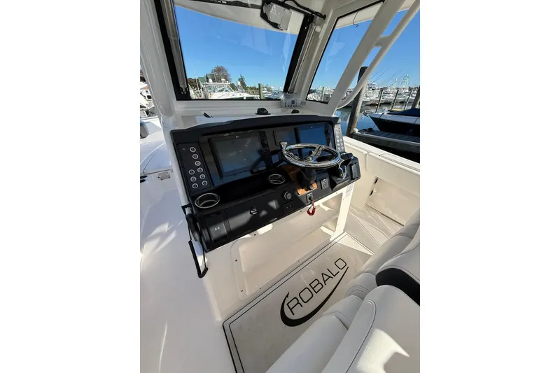 Slide: The Image of 2025 Robalo R300 Center Console boat interior with storage compartment open. - 10