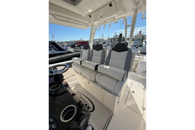 Slide: The Image of 2025 Robalo R300 Center Console boat docked, featuring dual outboard engines. - 11