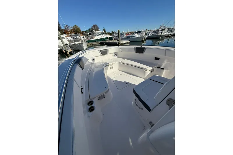 Slide: The Image of 2025 Robalo R300 Center Console boat interior with modern dashboard and steering wheel. - 15
