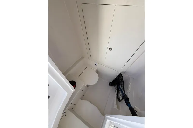 Slide: The Image of 2025 Robalo R300 Center Console boat interior with three cushioned seats and steering area. - 16