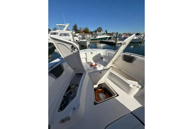 Slide: The Image of 2025 Robalo R300 Center Console boat dashboard with modern controls and navigation screens. - 18