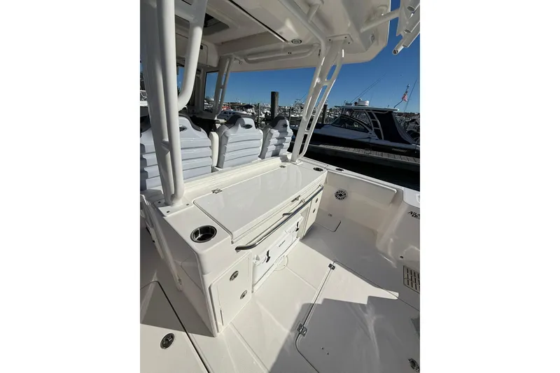Slide: The Image of Radar system on 2025 Robalo R300 Center Console boat under clear blue sky. - 25