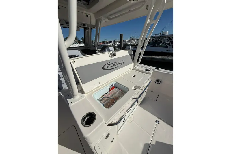 Slide: The Image of 2025 Robalo R300 Center Console boat with Yamaha engines on a calm waterway. - 5
