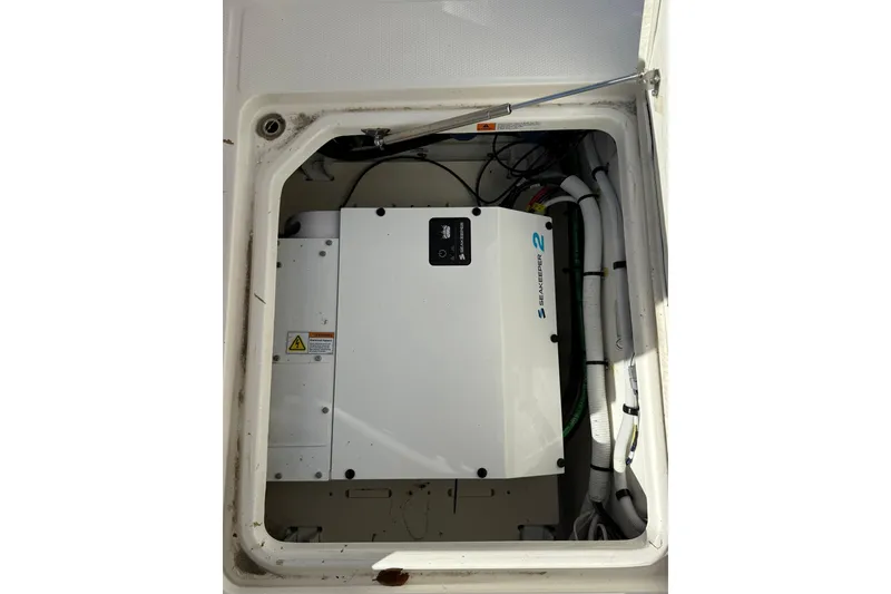 Slide: The Image of 2025 Robalo R300 Center Console boat with dual 350 V6 engines docked at marina. - 8