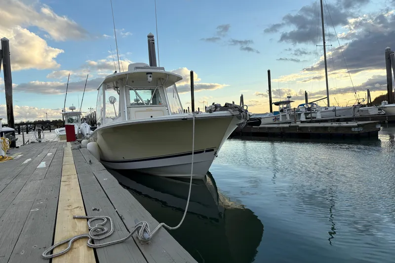 The Image of 2006 Regulator 32 Forward Seating boat docked at marina during sunset. - 0