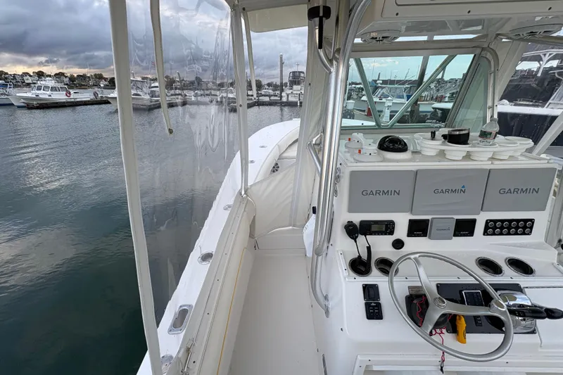 Slide: The Image of 2006 Regulator 32 Forward Seating boat with Garmin navigation, docked in a marina. - 11