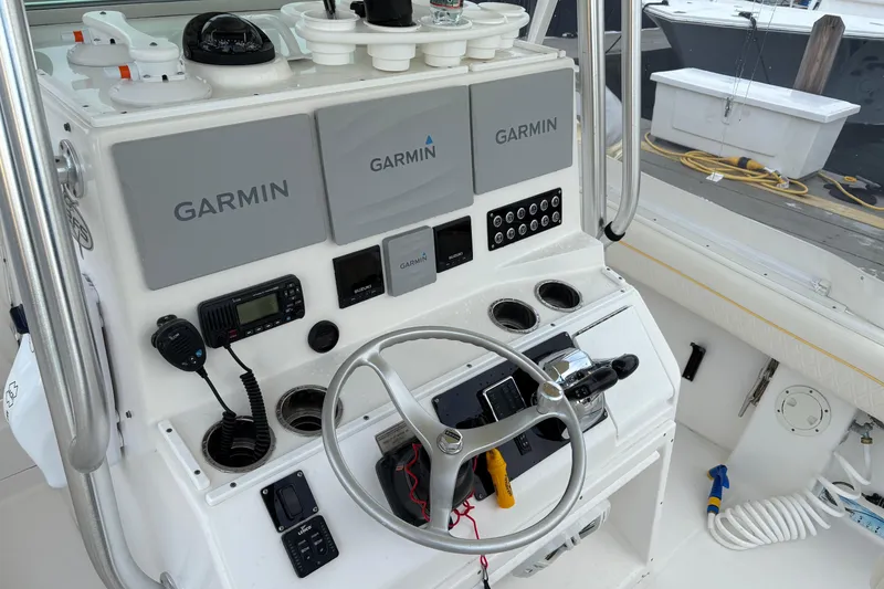 Slide: The Image of Control panel of a 2006 Regulator 32 Forward Seating boat with Garmin electronics. - 13