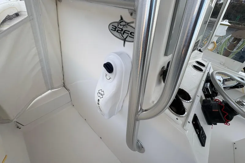 Slide: The Image of 2006 Regulator 32 Forward Seating boat interior with steering wheel and control panel. - 16