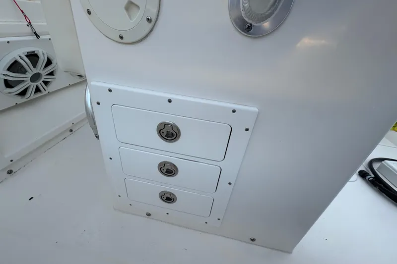 Slide: The Image of 2006 Regulator 32 Forward Seating boat storage compartments with secure locks and speaker system. - 18