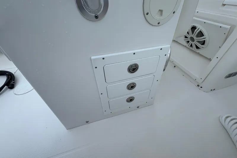 Slide: The Image of 2006 Regulator 32 Forward Seating boat interior with storage compartments and speaker. - 19