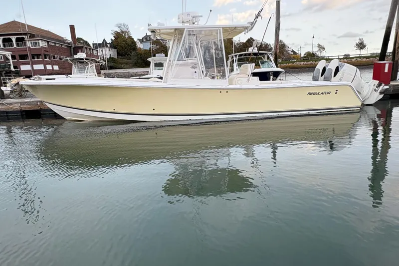 Slide: The Image of 2006 Regulator 32 Forward Seating boat docked in calm waters. - 2