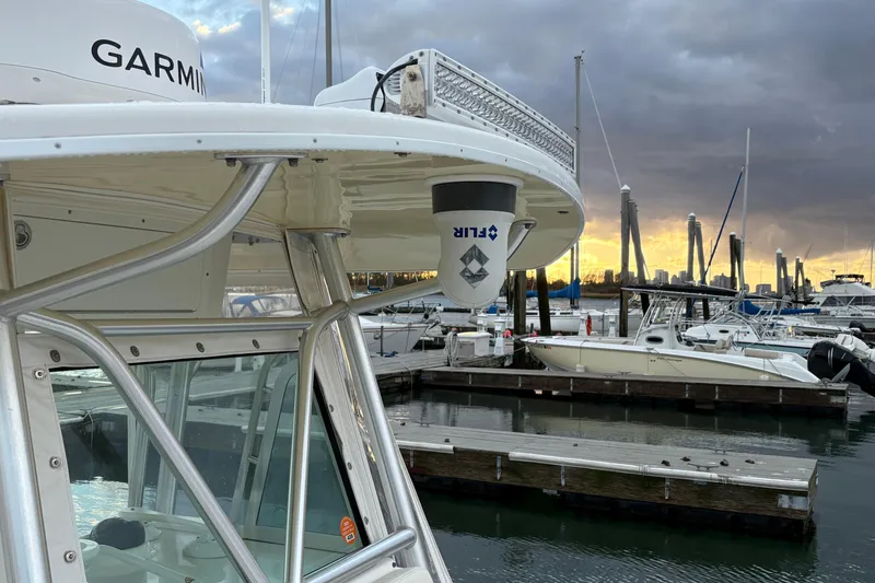 Slide: The Image of 2006 Regulator 32 Forward Seating boat with Garmin and FLIR equipment at marina during sunset. - 21