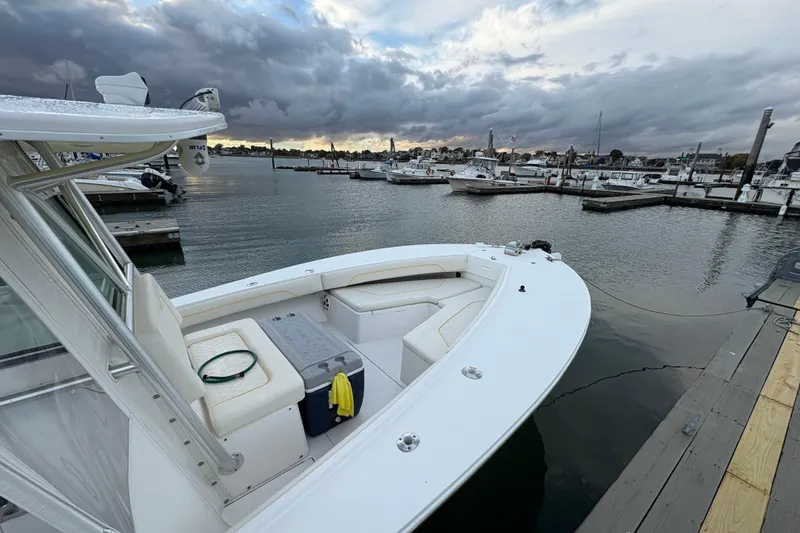 Slide: The Image of 2006 Regulator 32 Forward Seating boat docked at marina under cloudy sky. - 24