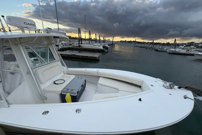 Slide: The Image of 2006 Regulator 32 Forward Seating boat docked at sunset with cloudy sky. - 25