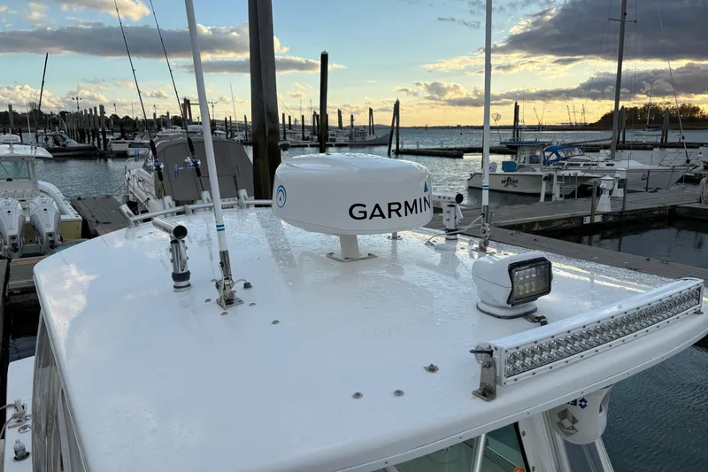 Slide: The Image of 2006 Regulator 32 Forward Seating boat with Garmin radar at marina during sunset. - 27