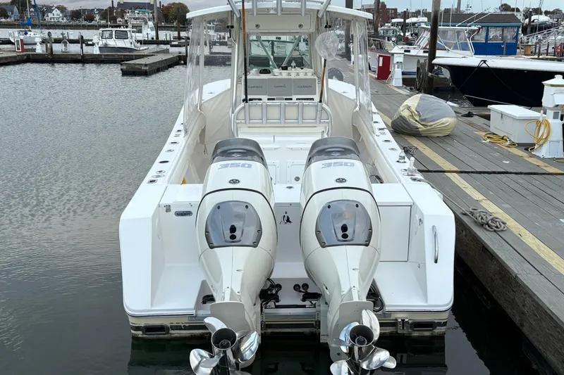 Slide: The Image of 2006 Regulator 32 Forward Seating boat with twin 350 engines docked at marina. - 5